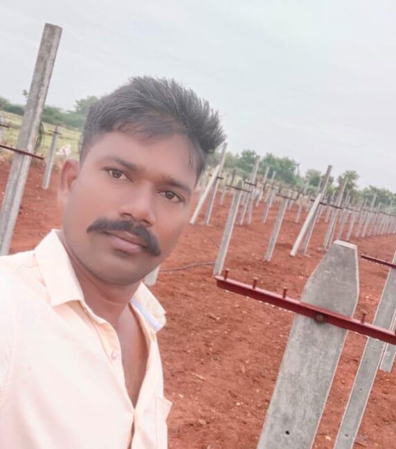 Mr Chandu with his draogn farm in the background
